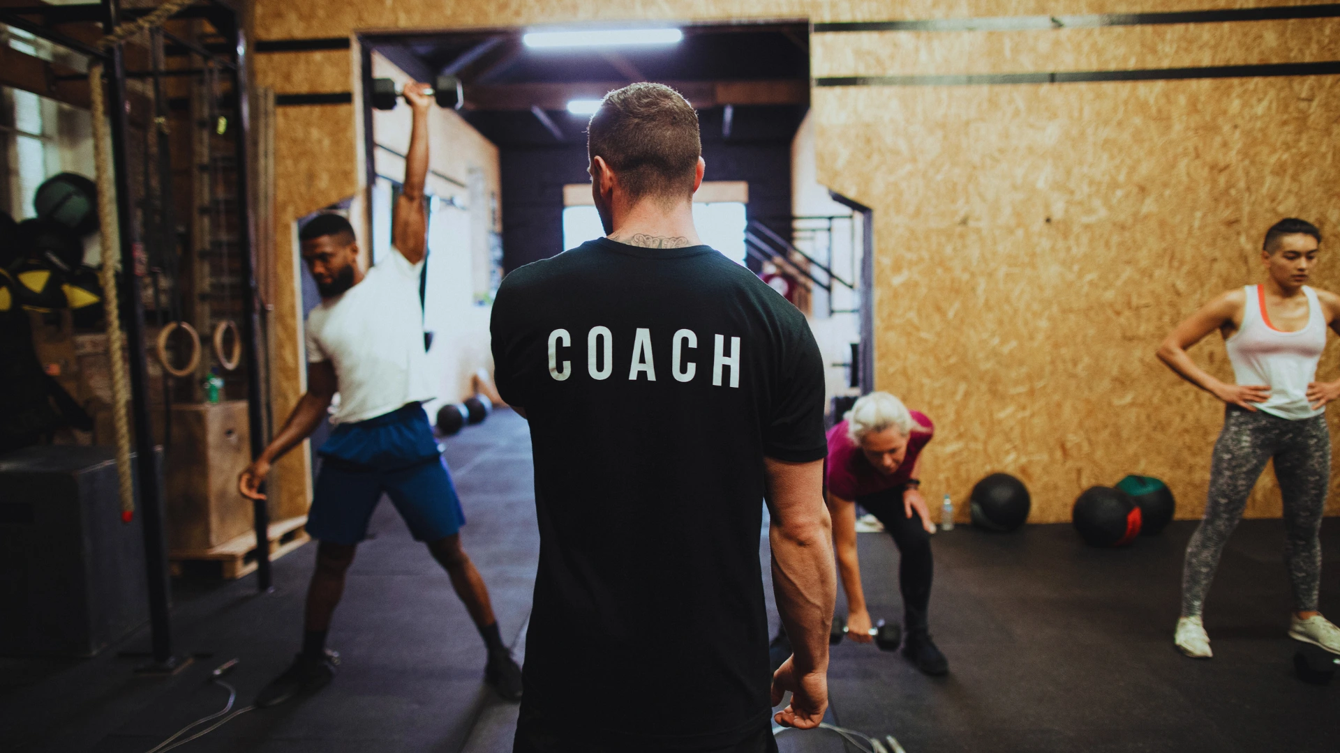 gym-coach-leading-group-fitness-training-session